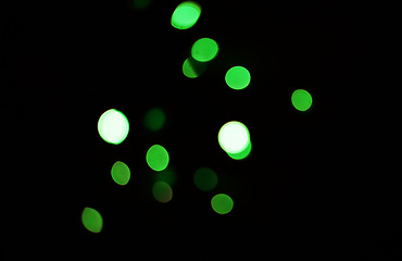 Image showing Green light, bokeh and dots on dark background isolated on a mockup space. Blur, black backdrop and defocused shine, sparkle or glitter at night for Christmas, holiday or party with magic of color