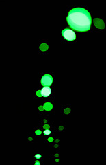 Image showing Bokeh, green particles and lights on black background with pattern, texture and mockup with cosmic aesthetic. Night lighting, sparkle dots and glow on dark wallpaper with space, color shine and flare