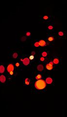 Image showing Bokeh, red and orange lights on black background with pattern, texture and mockup with cosmic aesthetic. Night lighting, sparkle particles and glow on dark wallpaper with space, color shine and flare