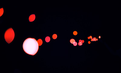 Image showing Bokeh, cosmic red dots and black background with pattern, texture and mockup with aesthetic lights. Night lighting, sparkle particles and glow on dark wallpaper with space, color shine and flare.