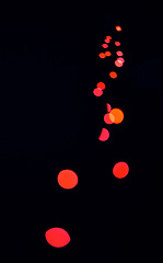 Image showing Bokeh, red lamp dots and black background with pattern, texture and mockup with cosmic aesthetic lights. Night lighting, sparkle particles and glow on dark wallpaper with space, color shine and flare