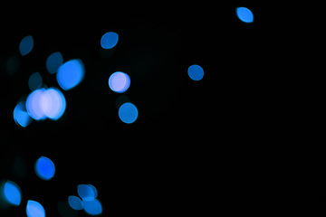 Image showing Bokeh, blue dots and mockup on black background with pattern, texture and lights with cosmic aesthetic. Night lighting, sparkle particles and glow on dark wallpaper with space, color shine and flare.