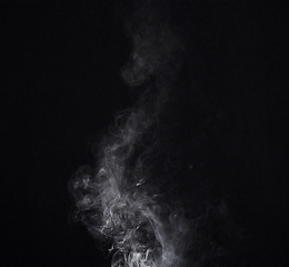 Image showing Smoke, smog or gas in a studio with dark background by mockup space for magic effect with abstract. Incense, steam or vapor mist moving in air for cloud fog pattern by black backdrop with mock up.