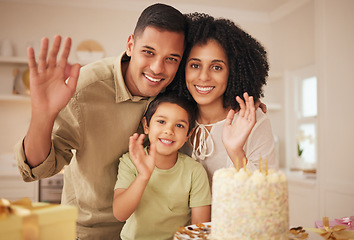 Image showing Family, birthday cake and wave portrait with mother, father and kid with present at home with smile. Gift, parents and happy boy in a kitchen with dessert, giving and event with party and celebration