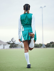 Image showing Back, legs and a woman hockey player stretching for the start of a game or competition outdoor. Sports, fitness and warm up with an athlete getting ready for a training workout or practice on a field