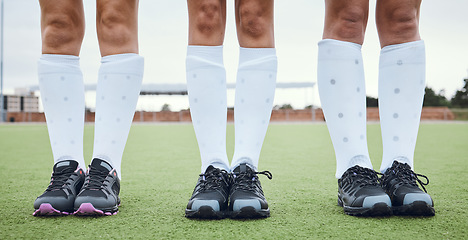 Image showing Legs, shoes and woman hockey team outdoor on a field for a game or competition together in summer. Fitness, training or sports with people on a pitch of a grass for exercise or teamwork on match day