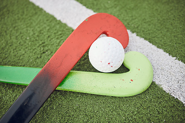 Image showing Hockey, stick and ball on green, field or pitch with sports equipment for game, competition or match on ground or floor. Artificial grass, heart or gear on turf for training in sport championship