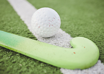 Image showing Hockey, stick and ball on green, field or pitch with sports equipment for game, competition or match on ground or floor. Artificial grass, turf or gear for training sport championship on astroturf
