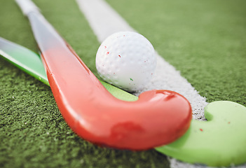 Image showing Field, hockey and stick with ball on green, pitch or sports equipment for game, competition or match on ground or floor. Grass, turf or gear for sport or training for championship on astroturf