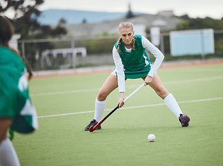 Image showing Field, hockey and woman in sports, game or action in competition with ball, stick and team on artificial grass. Sport, teamwork and women play in training, exercise or workout for goals in match