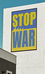 Image showing City, buildings and banner to stop war Ukraine, Russia and opinion for peace, support and solidarity. Poster, skyscraper and vote for kindness, love and no violence with freedom, justice or respect