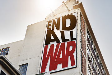 Image showing Building, billboard and poster with information on wall with war, propaganda or advertising activism campaign in city. End, conflict and sign or banner to protest politics, violence or global crisis