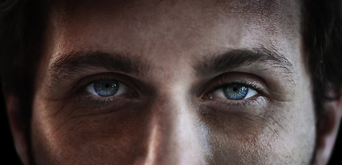 Image showing Eyes, vision and a man closeup in studio on a dark background for mental health or depression. PTSD, trauma or awareness and pupil portrait of a person looking serious about a memory and idea