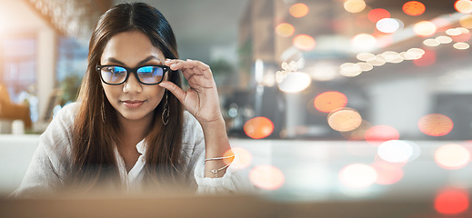 Image showing Student, woman and glasses on laptop at cafe for online education, e learning or remote work on banner or bokeh overlay. Young person on computer in vision, reading and online research at coffee shop