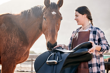 Image showing Horse, rider and woman with saddle on ranch for animal care, training and riding on farm. Agriculture, countryside and person with equipment for stallion for practice, freedom and adventure outdoors