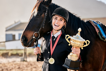 Image showing Portrait, equestrian and prize horse with a woman on a ranch for sports, training or a leisure hobby. Winner, trophy or award and a happy young rider in uniform with her stallion or mare outdoor