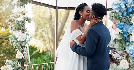 Image showing Happy black couple, wedding and kiss for love, marriage or commitment in support together. Married African woman and man kissing in embrace, trust or relationship of bride or groom in outdoor romance