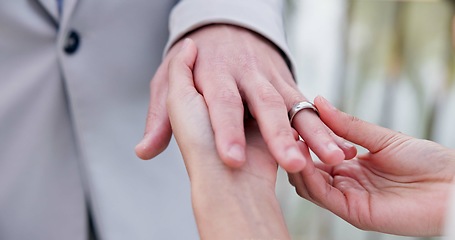 Image showing Couple, holding hands and ring for marriage, wedding or ceremony for commitment, love or support. Closeup of people getting married, vows or accessory for symbol of bond, relationship or partnership