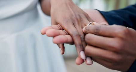 Image showing Couple, holding hands and ring for marriage, love or wedding in ceremony, commitment or support. Closeup of people getting married, vows or accessory for symbol of bond, relationship or partnership