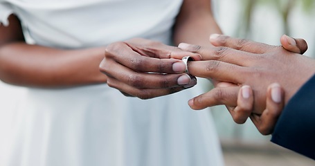 Image showing Couple, holding hands and ring for marriage, commitment or wedding in ceremony, love or support. Closeup of people getting married, vows or accessory for symbol of bond, relationship or partnership