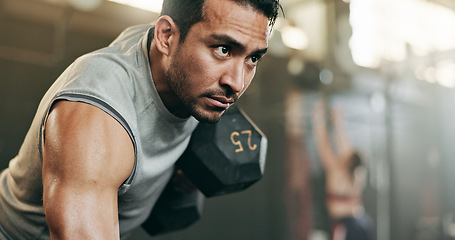 Image showing Serious man, dumbbell and weightlifting in workout, exercise or fitness at indoor gym. Active male person, bodybuilder or athlete lifting weight for intense arm training, strength or muscle at club