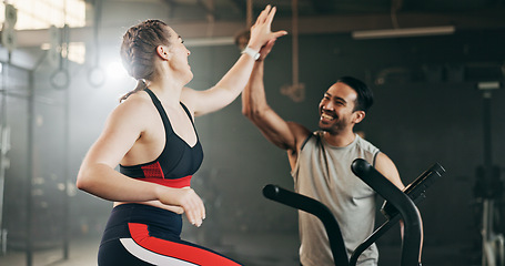 Image showing Woman, cycling and personal trainer in high five, motivation or fitness workout, exercise and training at gym. Man coaching female person on bicycle, machine or equipment in cardio at health club