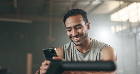 Image showing Happy asian man, phone and fitness on break in social media, communication or networking at gym. Active male person smile for online texting or chatting on mobile smartphone app at indoor health club