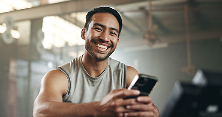 Image showing Happy asian man, phone and fitness in social media, communication or networking at gym. Portrait of active male person smile for online texting or chatting on mobile smartphone at indoor health club