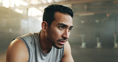 Image showing Fitness, face and breathing with a tired man in the gym, resting after an intense workout. Exercise, sweating and fatigue with a young athlete in recovery from training for health or wellness