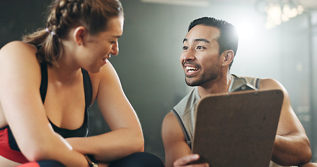 Image showing Man, woman and clipboard with talking in gym, sign up and planning for ideas, workout and smile with info. Personal trainer, paperwork and client for fitness, checklist and recruitment for wellness