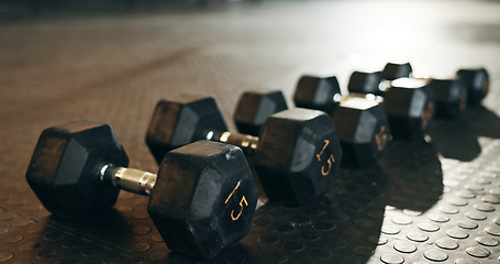 Image showing Fitness, background and dumbbells in empty gym for exercise, bodybuilding workout and sports training. Closeup of heavy steel weights, equipment and iron on floor in wellness club for muscle power