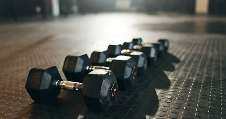 Image showing Fitness, background and dumbbells in empty gym for exercise, bodybuilding workout and sports training. Closeup of heavy steel weights, equipment and iron on floor in wellness club for muscle power