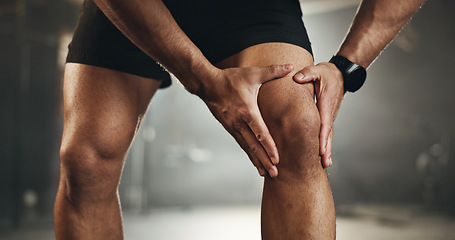 Image showing Fitness, knee pain and hands of man at gym for training with muscle, problem or arthritis. Sports, injury and leg of male athlete with joint massage for fibromyalgia, osteoporosis or bone accident