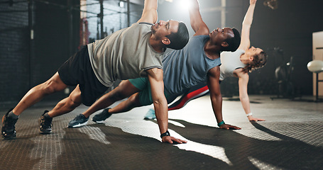 Image showing Gym, men and women in floor exercise for strong body, muscle development and balance power. Commitment, motivation and fitness team with personal trainer, training with focus and workout mindset.