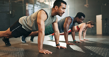 Image showing Gym, group fitness and push up exercise for power, sports challenge and muscle on ground. Serious asian man, bodybuilder and performance training on floor with friends, workout class or strong people