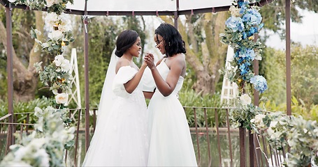 Image showing Women, wedding and lesbian dancing outdoor together at ceremony for celebration, happiness and romance. Marriage, love and lgbtq people holding hands and moving with smile in elegant dress in nature