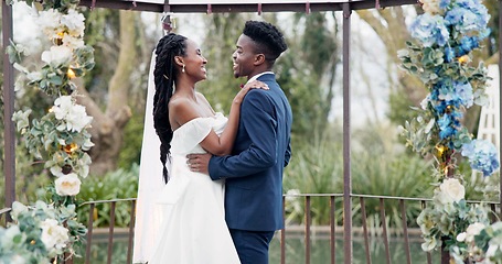 Image showing Wedding, dance and black couple in garden with love, celebration and excited future together. Gazebo, man and woman at luxury marriage reception with flowers, music and happiness at party in nature.