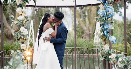 Image showing Wedding, dance and kiss, black couple in garden with love, celebration and excited for future together. Gazebo, man and woman at marriage reception with flowers, music and happiness at outdoor party