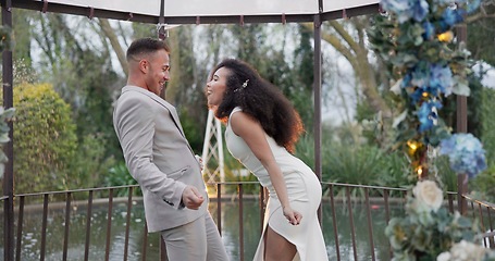 Image showing Wedding, fun dance and happy couple in garden with love, celebration and excited for future together. Gazebo, man and woman at marriage reception with flowers, music and happiness at party in nature.