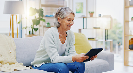 Image showing Relax, tablet and senior woman on sofa in living room scroll on social media, mobile app or the internet. Rest, online and elderly female person browsing on website with technology in lounge at home.