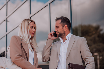 Image showing Modern business couple after a long day's work, walking together towards the comfort of their home, embodying the perfect blend of professional success and personal contentment.