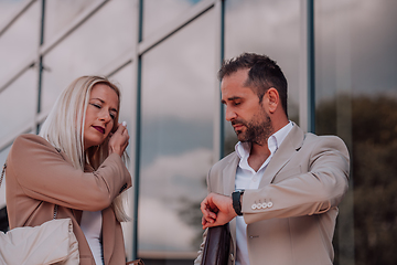 Image showing Modern business couple after a long day's work, walking together towards the comfort of their home, embodying the perfect blend of professional success and personal contentment.