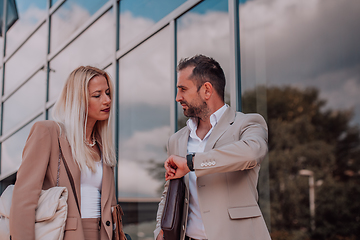 Image showing Modern business couple after a long day's work, walking together towards the comfort of their home, embodying the perfect blend of professional success and personal contentment.