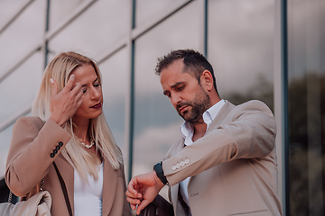 Image showing Modern business couple after a long day's work, walking together towards the comfort of their home, embodying the perfect blend of professional success and personal contentment.