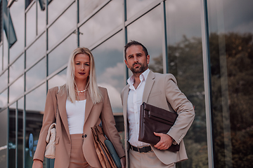 Image showing Modern business couple after a long day's work, walking together towards the comfort of their home, embodying the perfect blend of professional success and personal contentment.