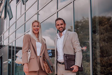 Image showing Modern business couple after a long day's work, walking together towards the comfort of their home, embodying the perfect blend of professional success and personal contentment.