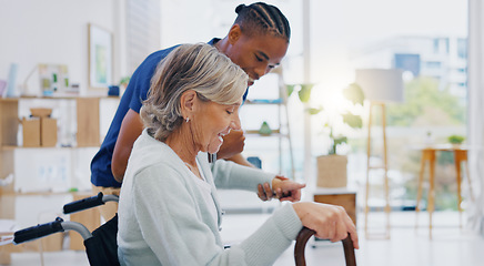 Image showing Help, talking and carer with a disabled woman in a house for a consultation, support or service. Happy, disability and an African male nurse helping senior woman from a wheelchair in nursing home