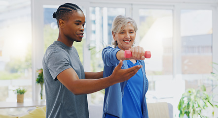 Image showing Elderly woman, dumbbells and rehabilitation therapist for exercise in a nursing home. Happy senior patient with physiotherapist man or nurse for healing, health and physiotherapy for muscle and body