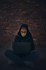 Image showing Hacker, woman in basement and laptop, information technology for coding and database with phishing and cyber crime. Cybersecurity, programming or hacking, criminal with pc for ransomware and firewall