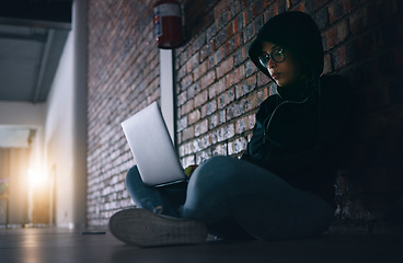 Image showing Hacker, woman in dark room with laptop and programming, phishing and cyber crime with database or server. Cybersecurity, information technology and criminal with pc, ransomware and firewall breach